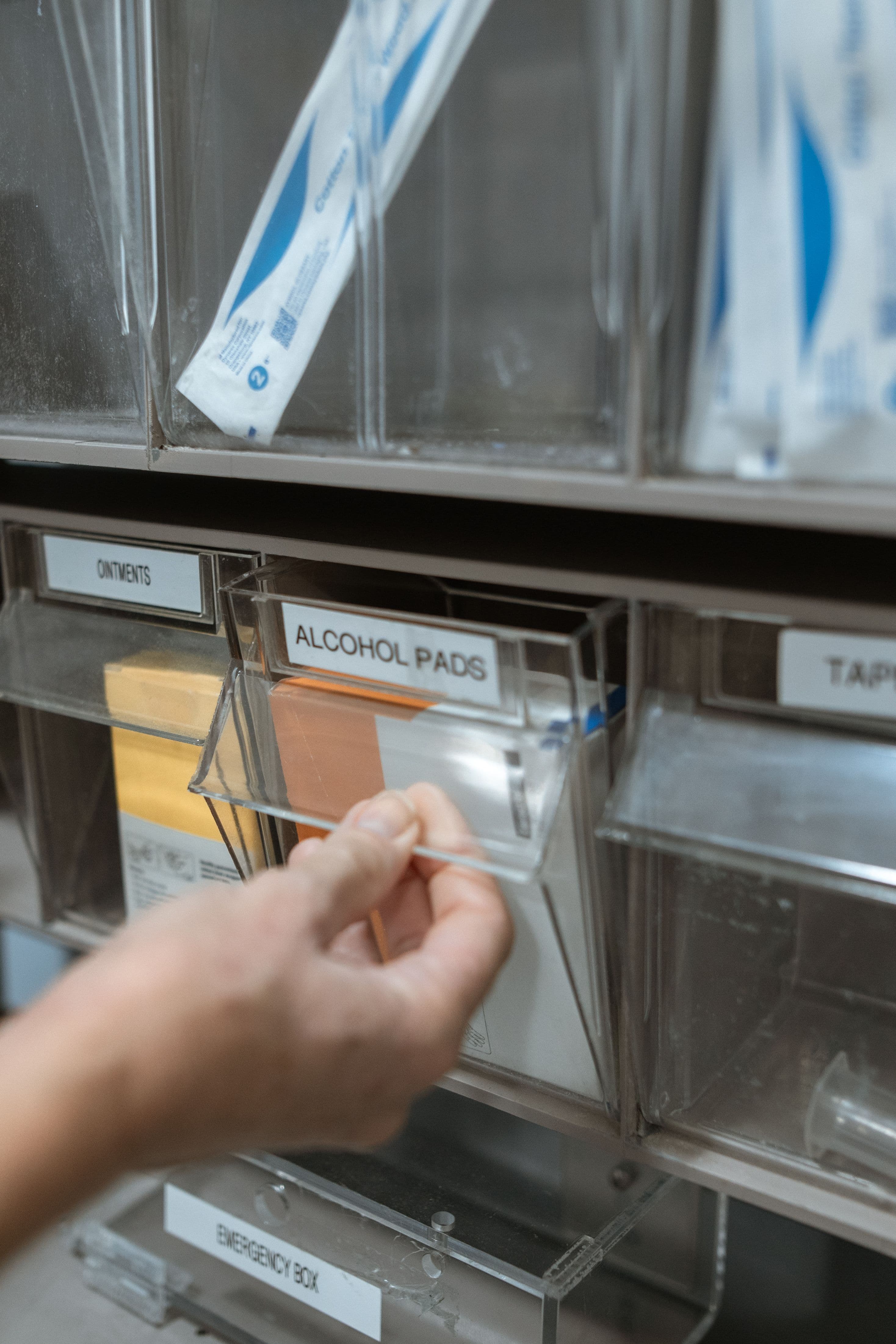 Hands counting stock against a shelf